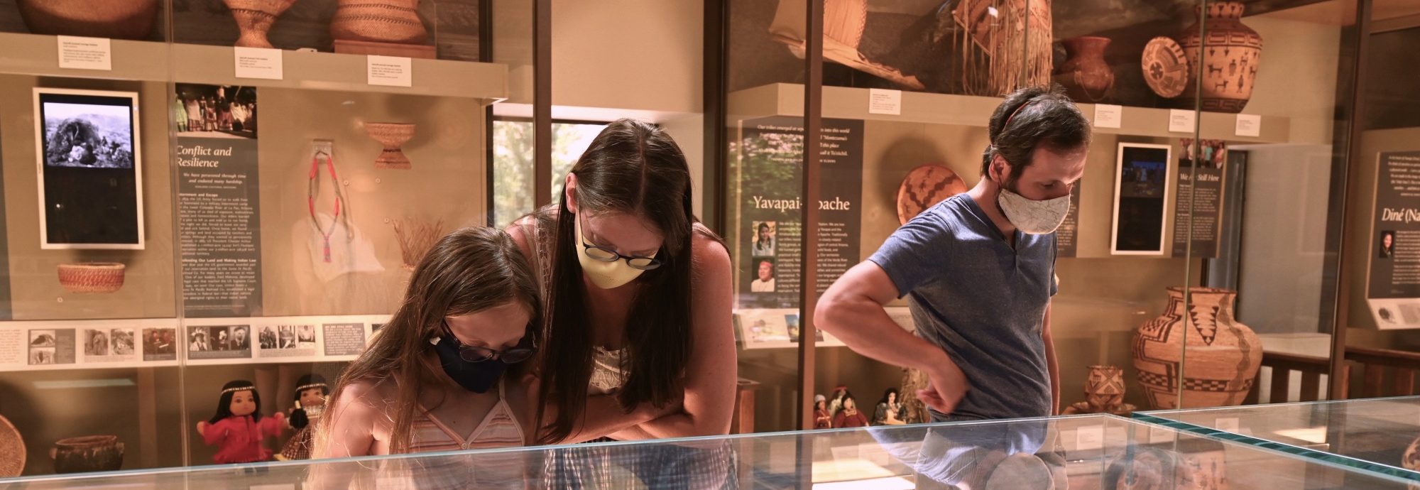 A family looking at a display case