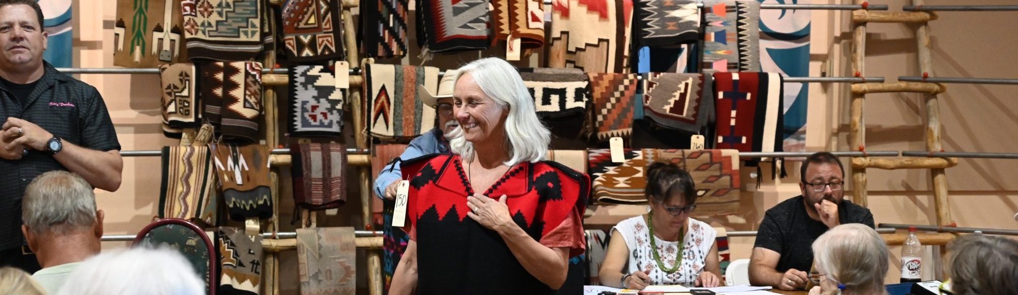 A volunteer at a rug auction