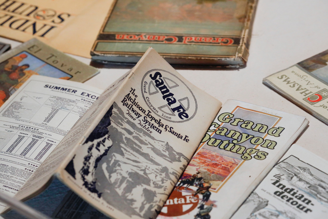 Brochures and books from the early 20th century promote travel to the Southwest. They are part of the "Selling the Southwest" exhibit at the Museum of Northern Arizona in Flagstaff.