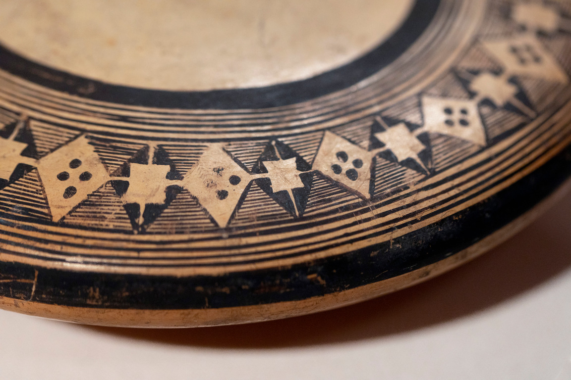 Detail view of Nampeyo black-on-yellow ceramic jar from the early 20th century. The jar is on display in the "Selling the Southwest" exhibit at the Museum of Northern Arizona in Flagstaff.